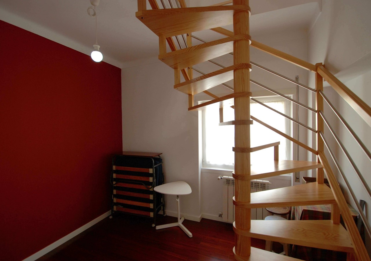 Room With Folding Bed And Stairway To Third Floor