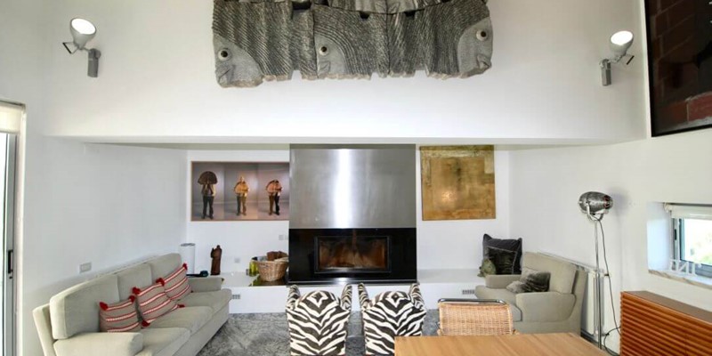 Seating area with fireplace in holiday villa, Lisbon Coast