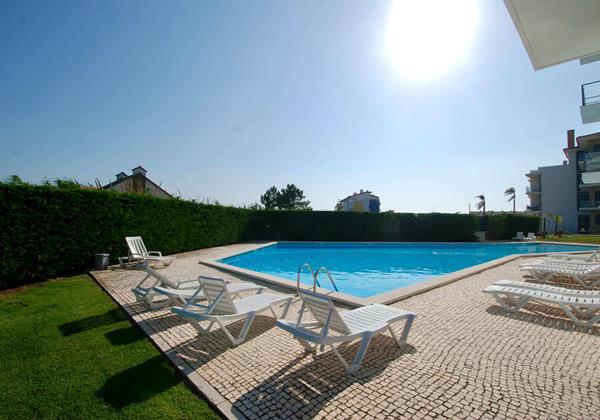 Pool area with sun loungers for guests