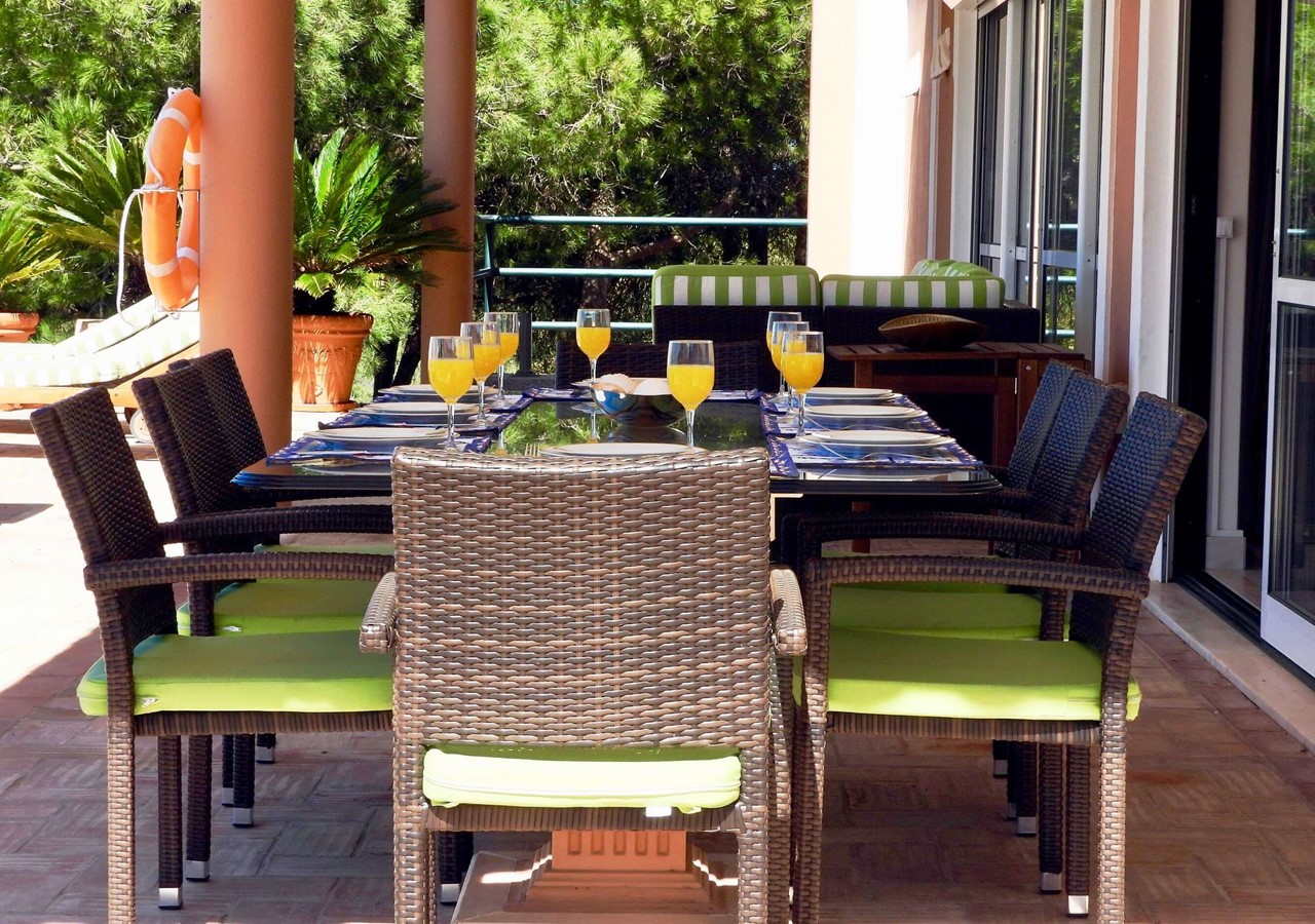 Dining area in covered terrace in luxury villa