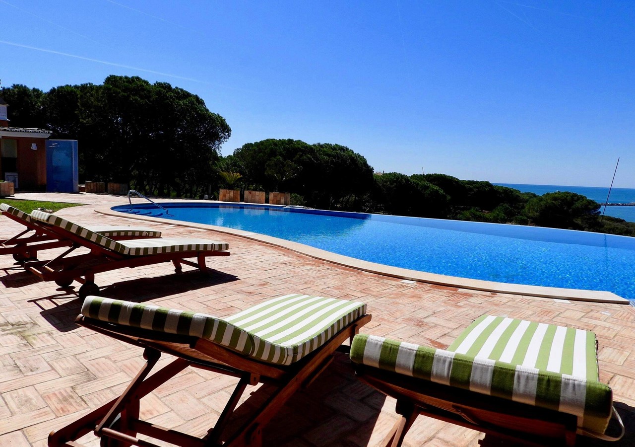 Infinity pool with sun loungers