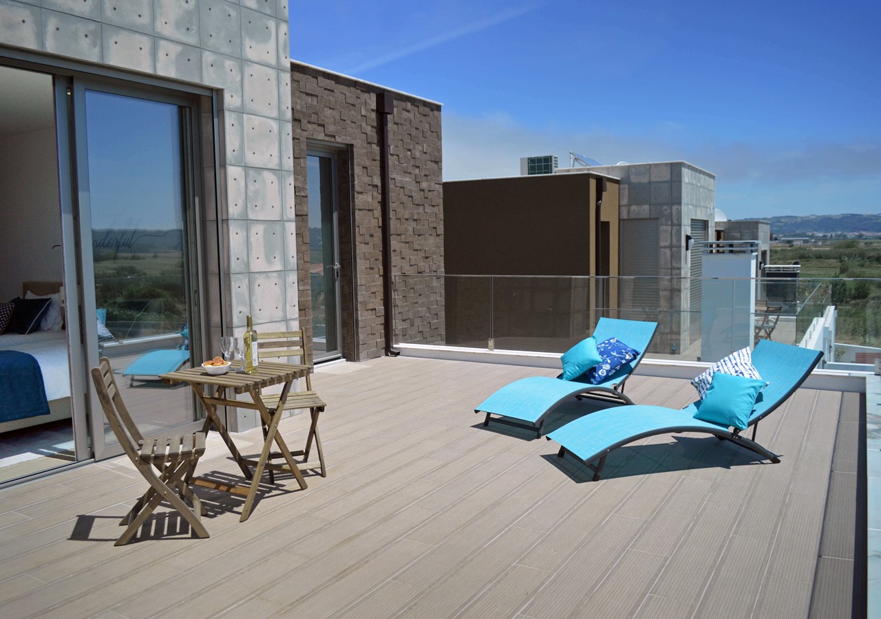 Large balcony with dining area and sun loungers