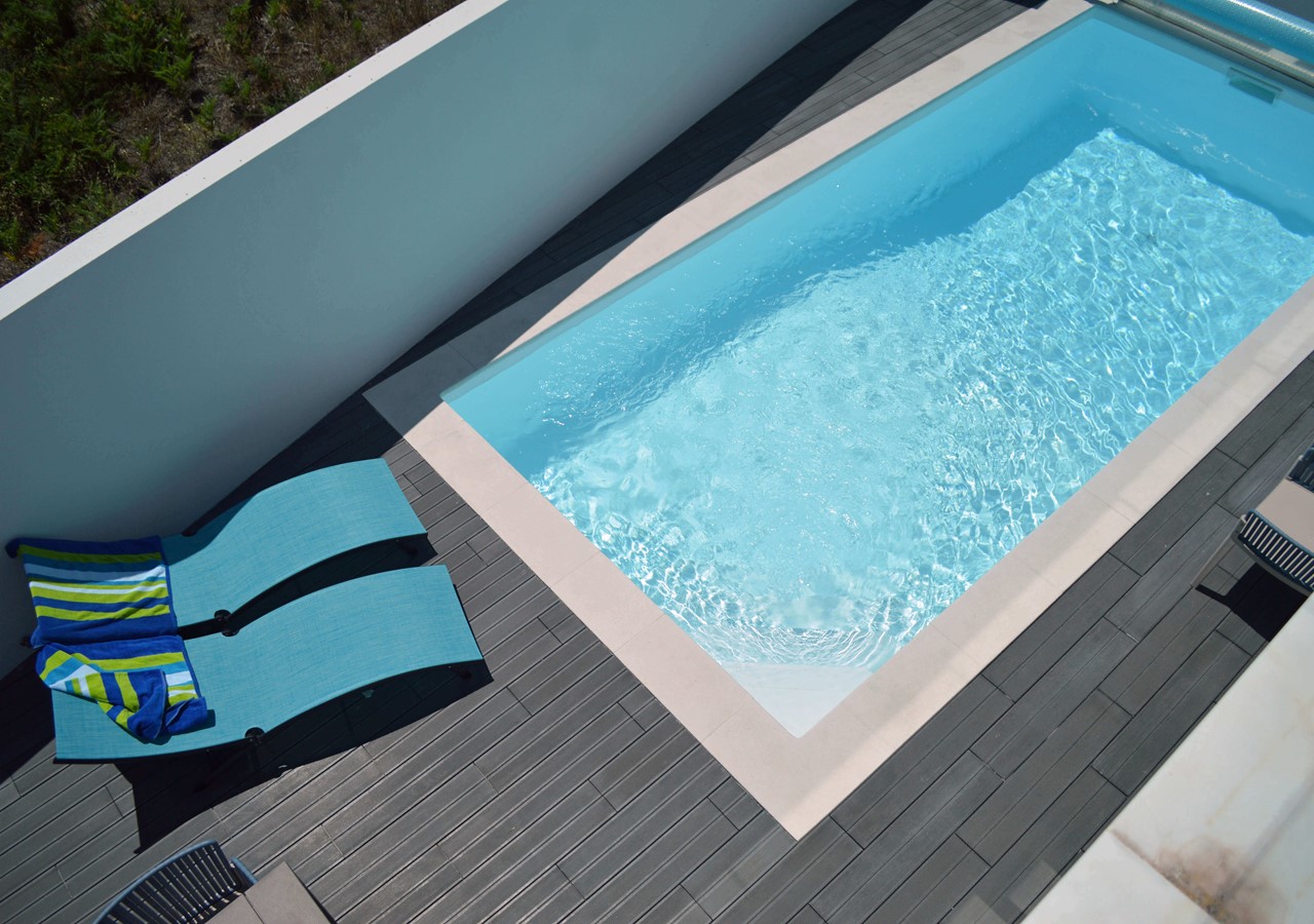 Pool area with sun loungers for guests